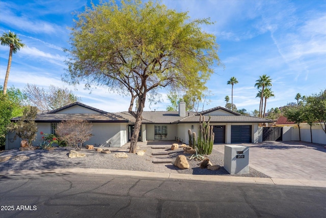 5919 N 45th St, Phoenix, AZ 85018 - ranch-style home with a garage, driveway, stucco siding, and a chimney