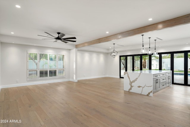 unfurnished living room featuring ceiling fan, beam ceiling, and light hardwood / wood-style flooring