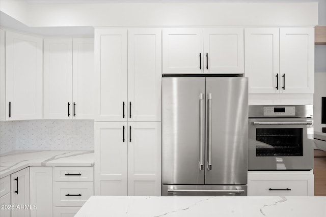 5919 N 45th St, Phoenix, AZ 85018 - kitchen featuring appliances with stainless steel finishes, white cabinets, and light stone countertops