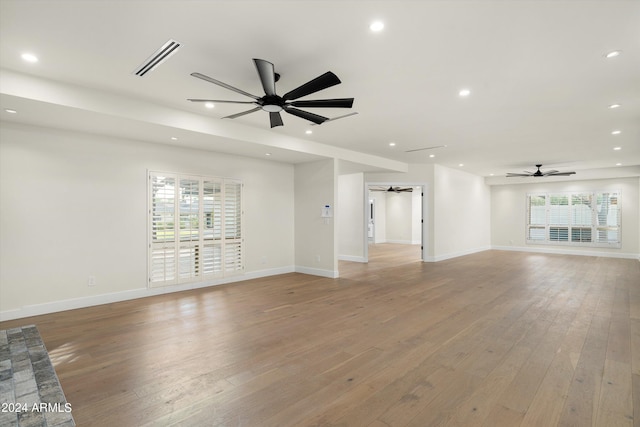 unfurnished living room with ceiling fan and light wood-type flooring