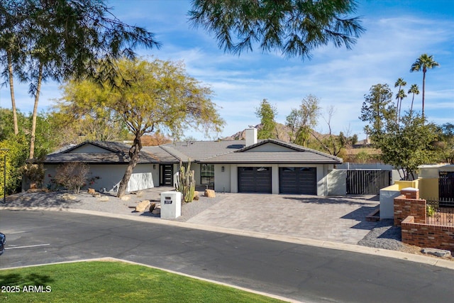 5919 N 45th St, Phoenix, AZ 85018 - view of front of house featuring a tile roof, an attached garage, a chimney, and stucco siding