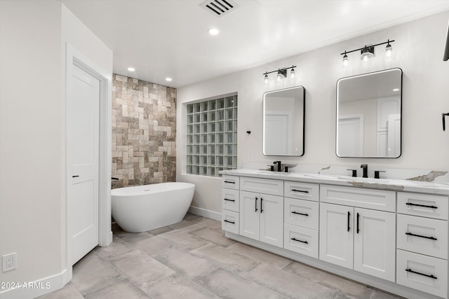 bathroom featuring vanity, tile walls, and a tub