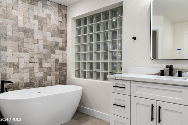 bathroom featuring a bathing tub, vanity, and tile patterned floors