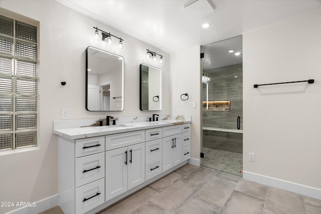 bathroom with vanity and a shower with shower door