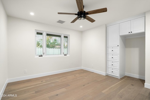 unfurnished bedroom with ceiling fan and light wood-type flooring