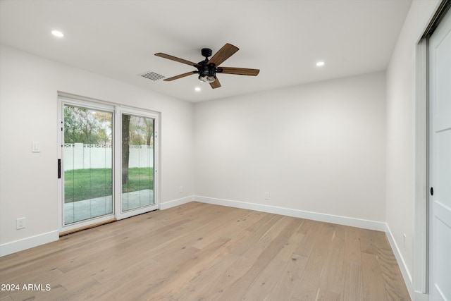 spare room featuring ceiling fan and light wood-type flooring