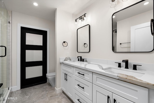 bathroom featuring vanity, an enclosed shower, and toilet