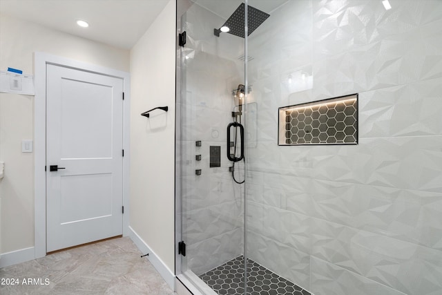 bathroom with a shower with shower door