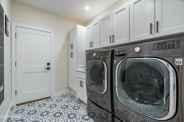 laundry area with cabinets and washing machine and dryer