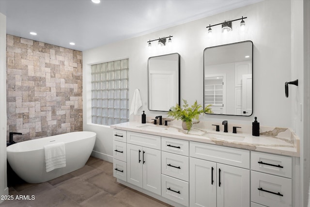 5919 N 45th St, Phoenix, AZ 85018 - bathroom with double vanity, a freestanding bath, tile walls, and recessed lighting