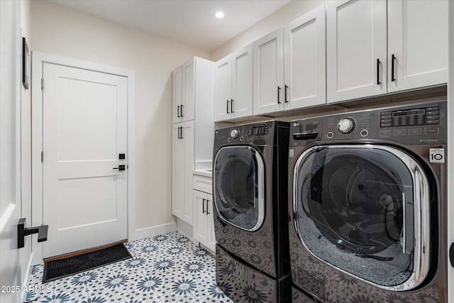 laundry room featuring cabinets and washing machine and dryer