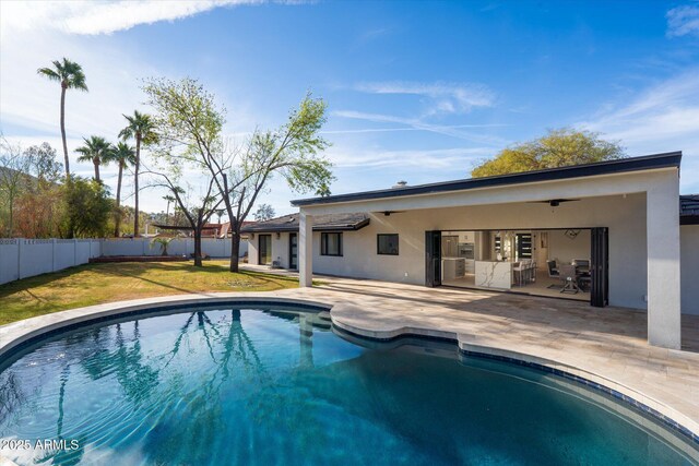 view of pool with a patio and a yard