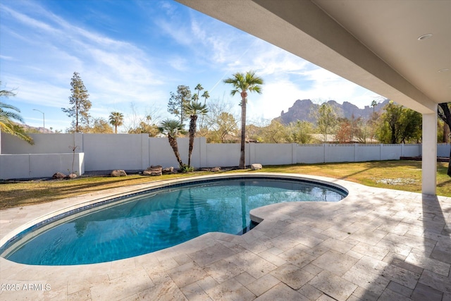 view of pool with a patio and a mountain view