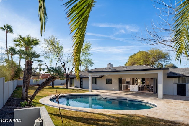 view of swimming pool featuring a yard and a patio