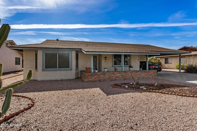 single story home with a carport and covered porch