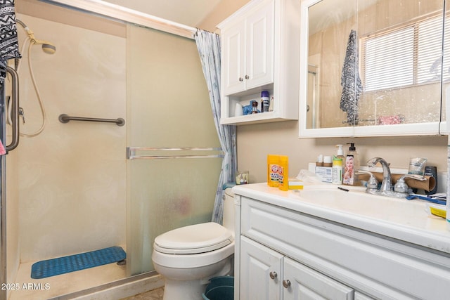 bathroom with vanity, toilet, and walk in shower