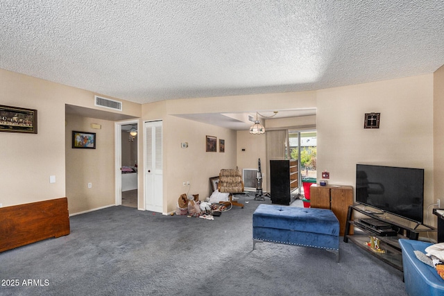 living room featuring carpet flooring and a textured ceiling