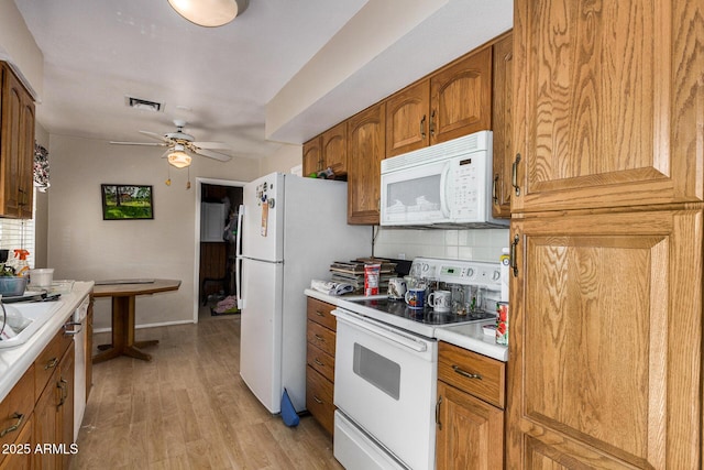 kitchen featuring ceiling fan, light hardwood / wood-style flooring, white appliances, and decorative backsplash