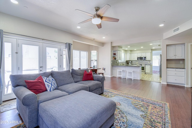 3921 W Jasper Dr, Chandler, AZ 85226 - living area featuring a ceiling fan, dark wood-style floors, french doors, recessed lighting, and baseboards