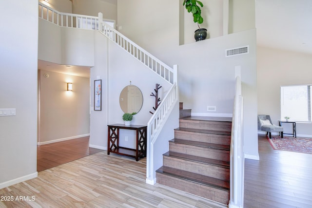 3921 W Jasper Dr, Chandler, AZ 85226 - staircase featuring a high ceiling, wood finished floors, and baseboards