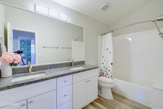 3921 W Jasper Dr, Chandler, AZ 85226 - full bathroom featuring double vanity, toilet, shower / bath combo, and wood finished floors