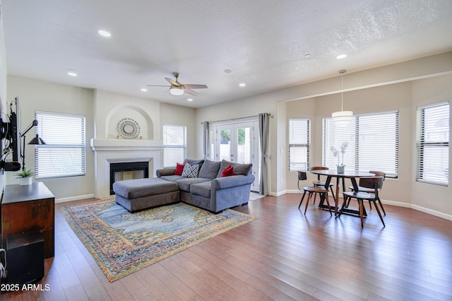 3921 W Jasper Dr, Chandler, AZ 85226 - living area with a ceiling fan, recessed lighting, a glass covered fireplace, wood finished floors, and baseboards