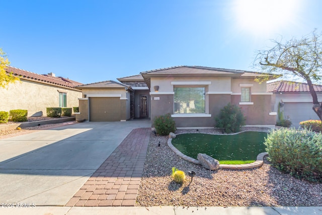 view of front of home featuring a garage, driveway, and stucco siding