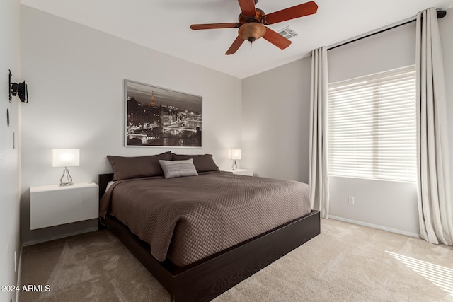 bedroom featuring ceiling fan, carpet flooring, visible vents, and baseboards