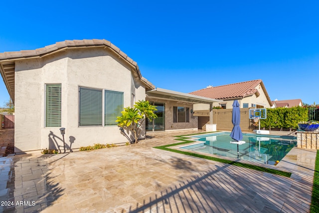 back of house featuring a patio, a fenced backyard, and stucco siding