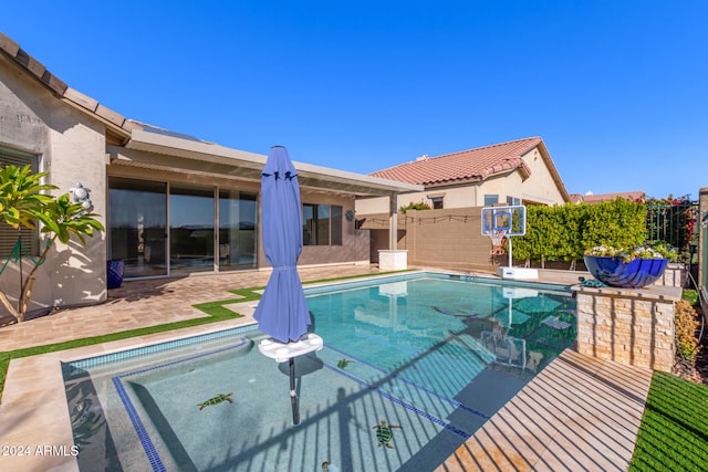 view of pool with fence and a patio