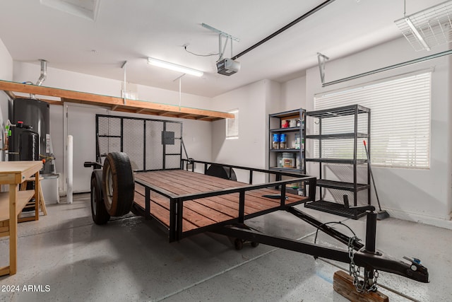 garage featuring gas water heater and a garage door opener