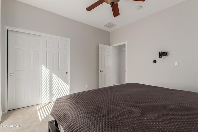 unfurnished bedroom with a ceiling fan, a closet, light carpet, and visible vents