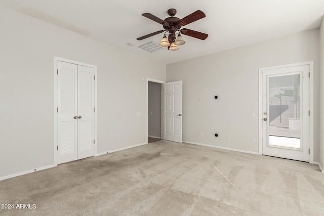 unfurnished bedroom featuring light colored carpet, visible vents, and baseboards