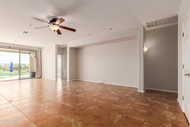 empty room with a ceiling fan, visible vents, and baseboards