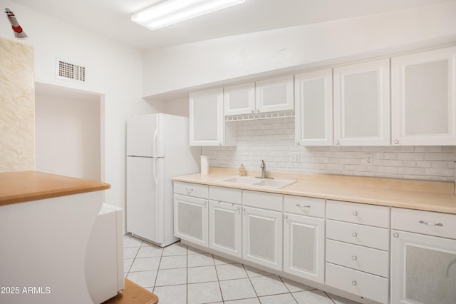 301 Whitton St, Sierra Vista, AZ 85635 - kitchen featuring visible vents, freestanding refrigerator, a sink, and white cabinetry