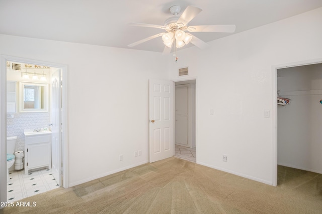 301 Whitton St, Sierra Vista, AZ 85635 - unfurnished bedroom featuring visible vents, light colored carpet, a closet, connected bathroom, and a walk in closet
