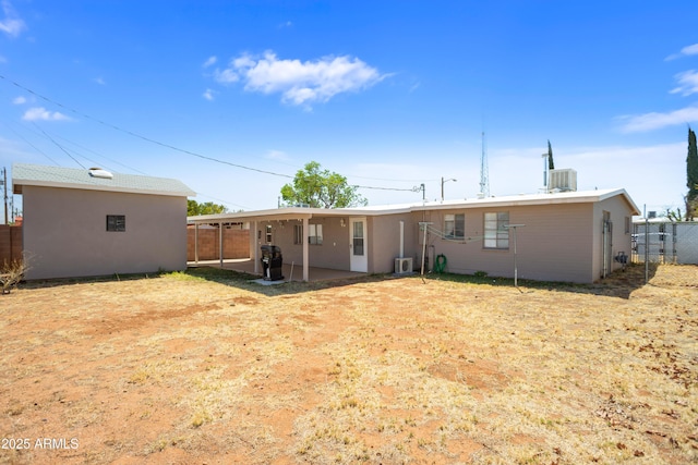 301 Whitton St, Sierra Vista, AZ 85635 - back of property featuring central AC unit, fence, a patio area, and an attached carport