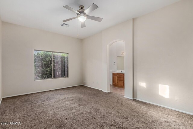 16846 N 49th Way, Scottsdale, AZ 85254 - carpeted empty room featuring arched walkways, a ceiling fan, and baseboards