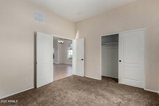 16846 N 49th Way, Scottsdale, AZ 85254 - unfurnished bedroom with carpet floors, a chandelier, a closet, baseboards, and tile patterned floors
