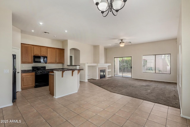 16846 N 49th Way, Scottsdale, AZ 85254 - kitchen featuring black appliances, light tile patterned floors, open floor plan, a kitchen breakfast bar, and dark countertops