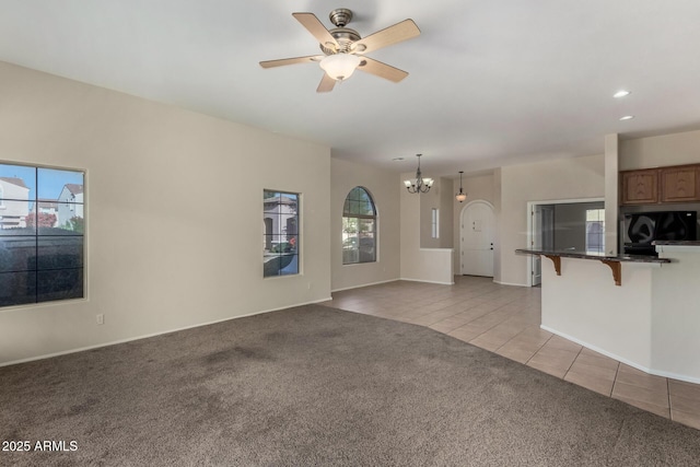 16846 N 49th Way, Scottsdale, AZ 85254 - unfurnished living room with light carpet, light tile patterned floors, a chandelier, a ceiling fan, and recessed lighting