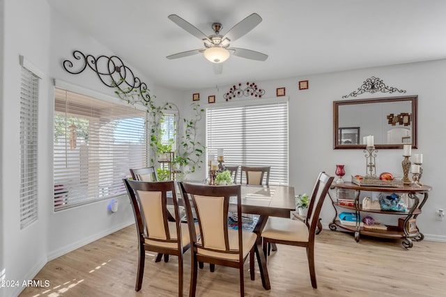 dining space with ceiling fan and light hardwood / wood-style flooring