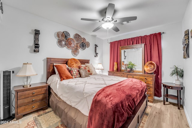 bedroom with light hardwood / wood-style flooring and ceiling fan