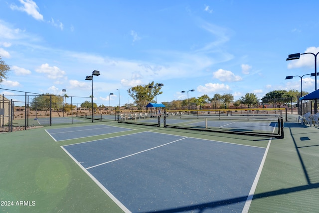 view of tennis court with basketball hoop