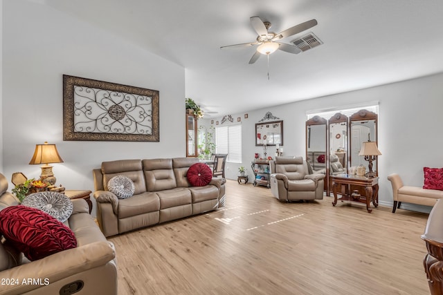 living room featuring ceiling fan and light hardwood / wood-style floors