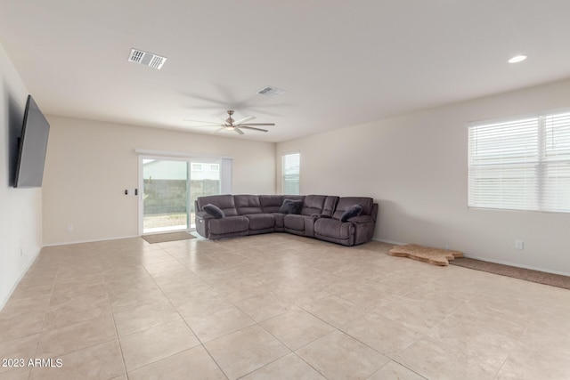 living room with ceiling fan and light tile patterned floors