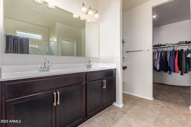 bathroom with tile patterned floors, vanity, and curtained shower