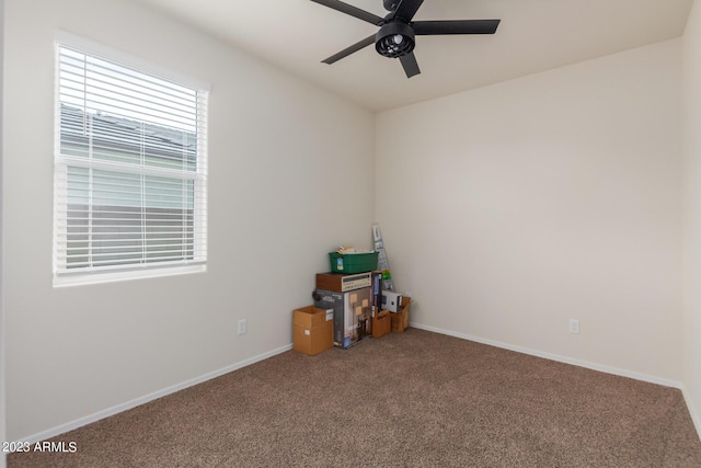 carpeted empty room featuring ceiling fan