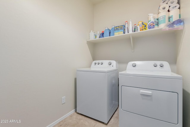 laundry area with light tile patterned flooring and separate washer and dryer