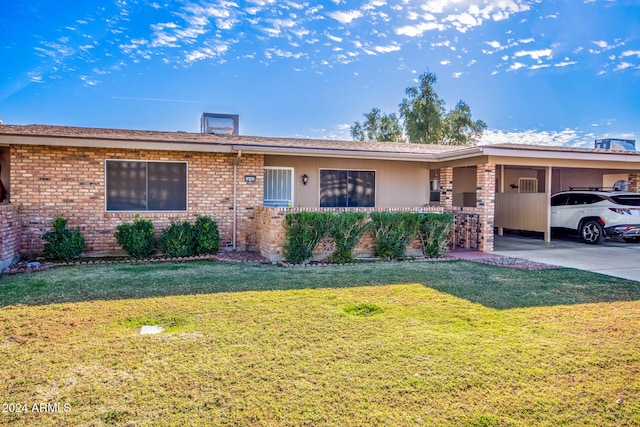 ranch-style home featuring a carport and a front yard